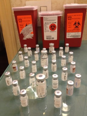 Vials from one round of IVF. The needles fill the canisters in the background.